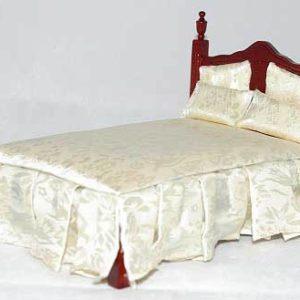 Double bed with ivory bedding and skirting