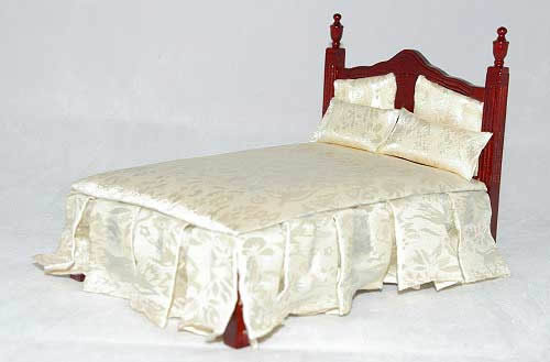 Double bed with ivory bedding and skirting
