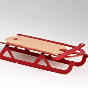 Red sled with pine base