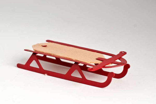 Red sled with pine base