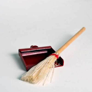 Straw broom and red dust pan