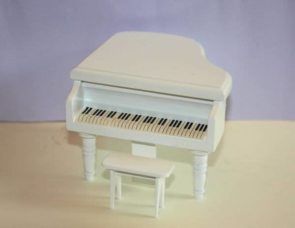 White timber grand piano and stool
