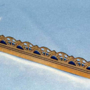 Long gold fire fender with ornate edge